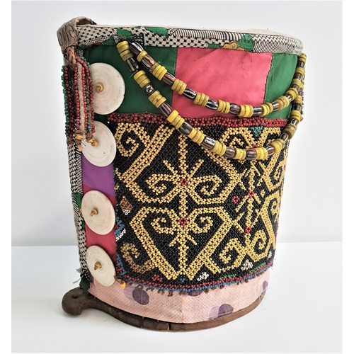 191 - DAYAK BORNEO BABY CARRIER
with a woven semi circular body covered in fabric with bead decoration and... 