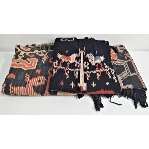 194 - THREE PUA KUMBU BORNEO BATIK THROWS
each decorated cloth made from two sections and decorated with a... 