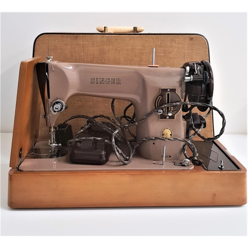 203 - SINGER SEWING MACHINE
with foot pedal and carry case, marked EM610418