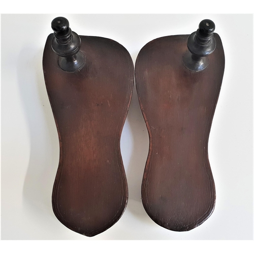 247 - PAIR OF INDIAN TEAK PADUKAS
of shaped outline with a rigid base raised on two blocks, with a knopped... 