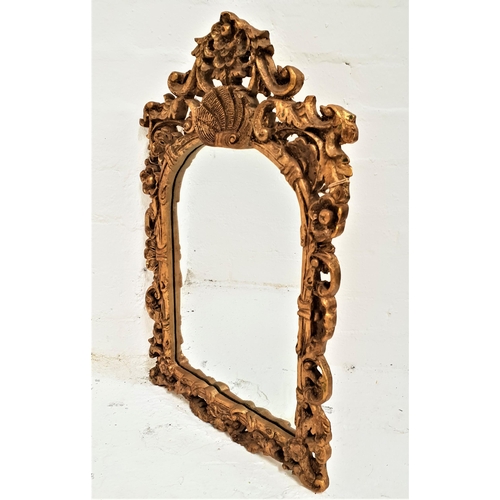 364 - ARCHED WALL MIRROR
in a carved and pierced giltwood frame with a plain plate, 59cm high