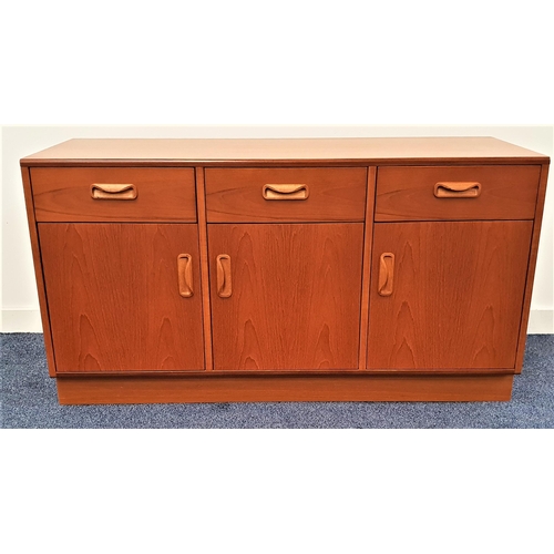 371 - G PLAN TEAK SIDE CABINET
with three frieze drawers above three cupboard doors, standing on a plinth ... 