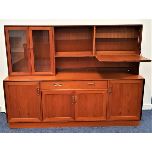 372 - G PLAN TEAK ILLUMINATED SIDEBOARD
the upper section with a pair of glass cupboard doors opening to r... 