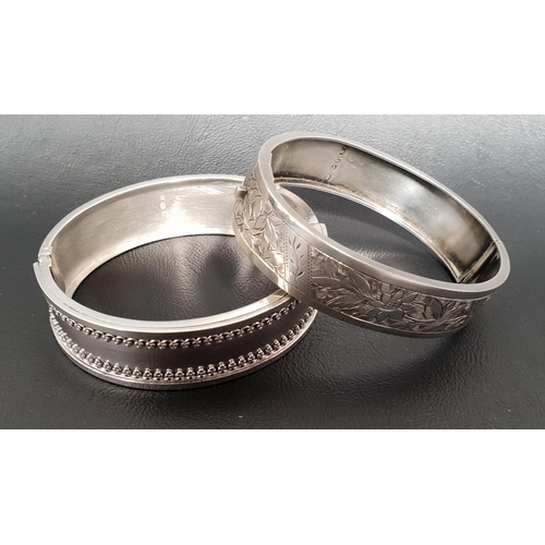 26 - TWO VICTORIAN SILVER HINGED BANGLES
one with floral engraved decoration, Birmingham hallmarks for 18... 