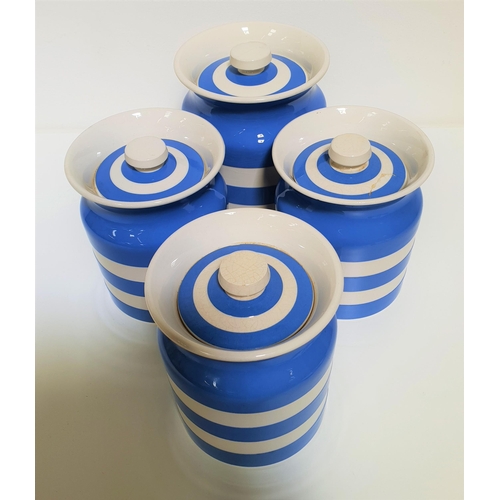 144 - FOUR ORIGINAL CORNISH KITCHENWARE STORAGE JARS
decorated in blue and white, all with lids, 15.5cm an... 