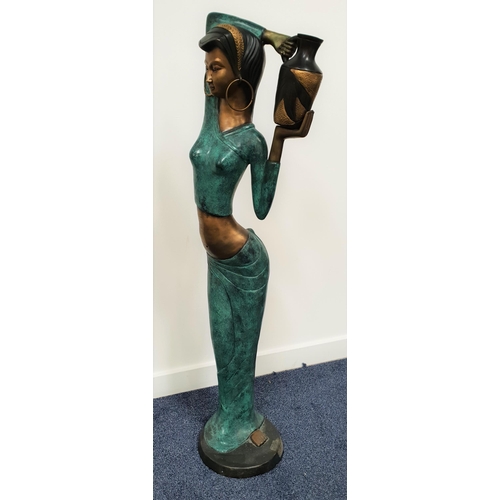 214 - LARGE BRASS MODEL OF AN INDIAN LADY
in traditional dress and carrying a large ewer, 123cm high