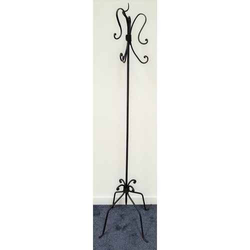 393 - DECORATIVE WROUGHT IRON COAT STAND
raised on four shaped supports, the central column with three pai... 