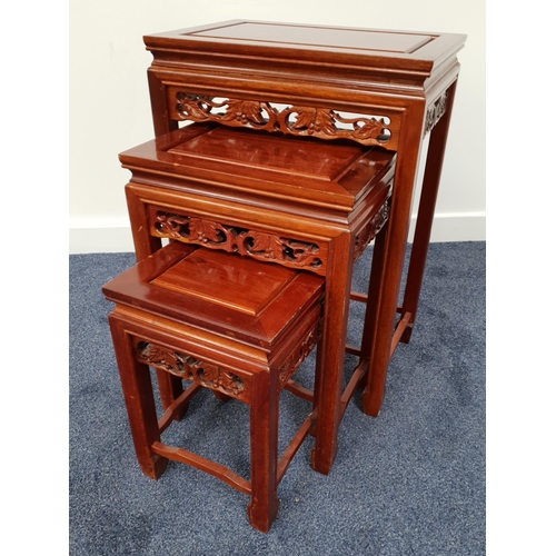 402 - NEST OF CHINESE HARDWOOD TABLES
with a carved top above a carved and pierced frieze, standing on cha... 