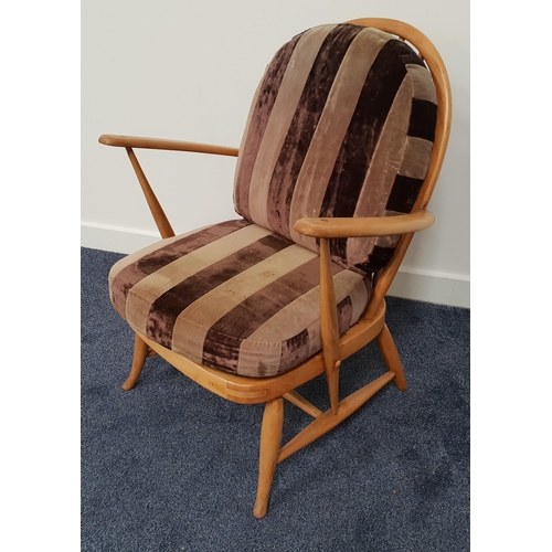 403 - ERCOL BEECH ARMCHAIR
with an arched spindle back above shaped arms, with a loose back and seat cushi... 