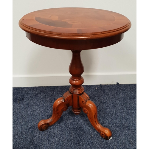 409 - CIRCULAR WALNUT AND CROSSBANDED OCCASIONAL TABLE
on a turned column with three outswept supports, 62... 