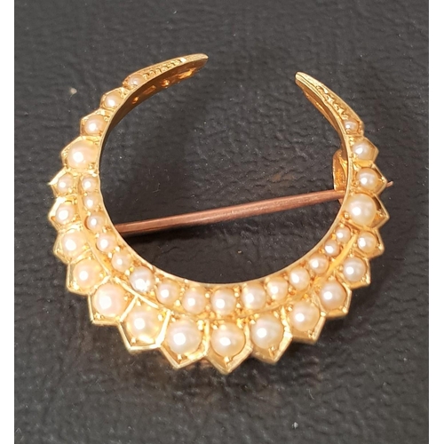 87 - SEED PEARL SET CRESCENT SHAPED BROOCH
in unmarked high carat gold, 2.2cm wide and approximately 3.4 ... 