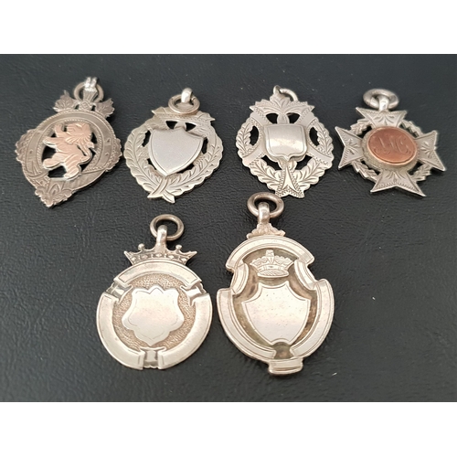 123 - SIX VICTORIAN AND LATER SILVER MEDAL FOBS
two with gold detail, one engraved to reverse 'Presented t... 