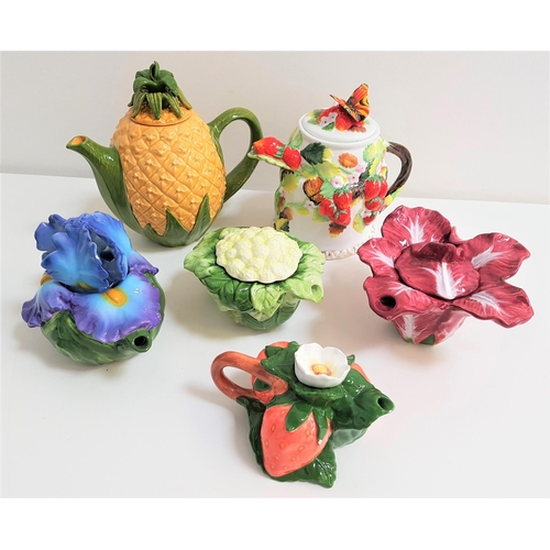 161 - SIX NOVELTY TEAPOTS
comprising a pineapple, a cabbage, a red cabbage, strawberries, an Iris and one ... 