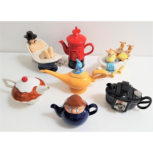 162 - SEVEN NOVELTY TEAPOTS
comprising a Wade Tetley teapot, a Pillar Box, a camera, a cup cake, Aladdin's... 