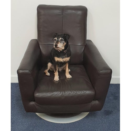 411 - LEATHER SWIVEL ARMCHAIR
in brown leather with a deep padded back, seat and arms, on a circular swive... 