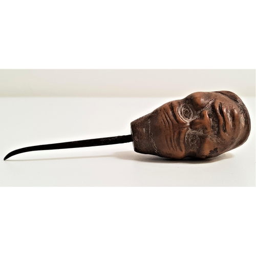 179 - CARVED COQUILLA NUT BUTTON HOOK
depicting two male faces, 9cm long