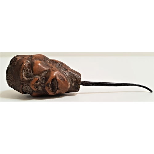 179 - CARVED COQUILLA NUT BUTTON HOOK
depicting two male faces, 9cm long