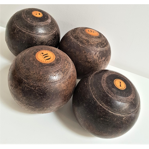 413 - SET OF FOUR LAWN BOWLS
in lignum vitae, size 3 and each with an inset disc marked 'J.O' (4)