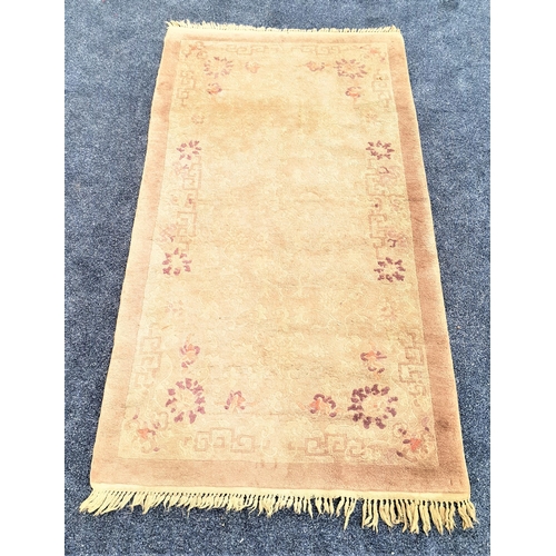 501 - CHINESE STYLE WASH RUG
with a pale brown and mauve ground with floral motifs, fringed, 189cm x 96cm