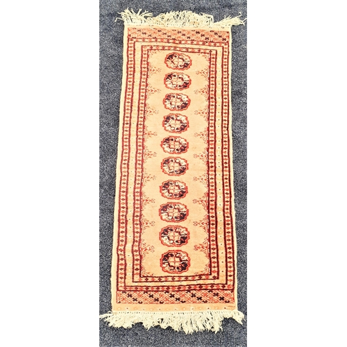 505 - BOKARA RUNNER
with a beige ground with ten central medallions encased with a multi layered border, f... 