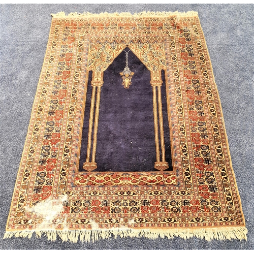 511 - BOKHARA SILK AND WOOL PRAYER RUG
with a central navy blue ground with twin gold pillars, encased by ... 