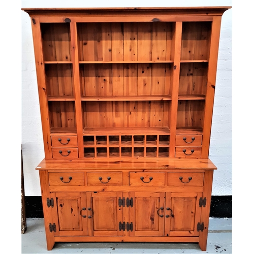 498 - WAXED PINE DRESSER
with a moulded top above three central drawers and fourteen bottle holders, flank... 