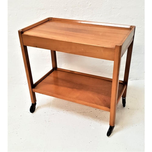 502 - TEAK TEA TROLLEY
with a rectangular top above two two pull out shelves above a lower shelf, on caste... 