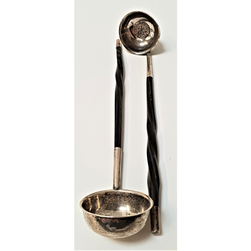 152 - TWO GEORGIAN SILVER TODDY LADLES
each with a cauldron shaped bowl centred with a flattened coin, bot... 