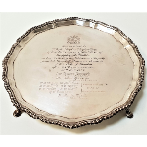 155 - GEORGE V SILVER PRESENTATION SALVER
with a scalloped decorative border, raised on four hoof feet, Lo... 