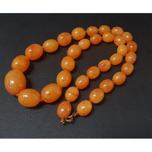 117 - GRADUATED AMBER COLOURED BEAD NECKLACE
the largest bead approximately 2.4cm long, the necklace appro... 