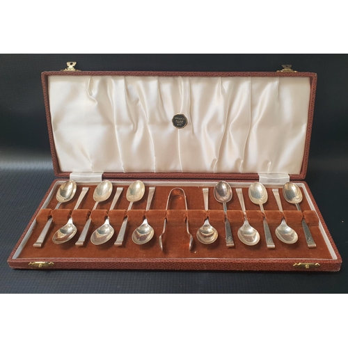 165 - ELIZABETH II TWELVE SILVER TEA SPOONS
with an engraved P to the terminals and a pair of sugar tongs,... 