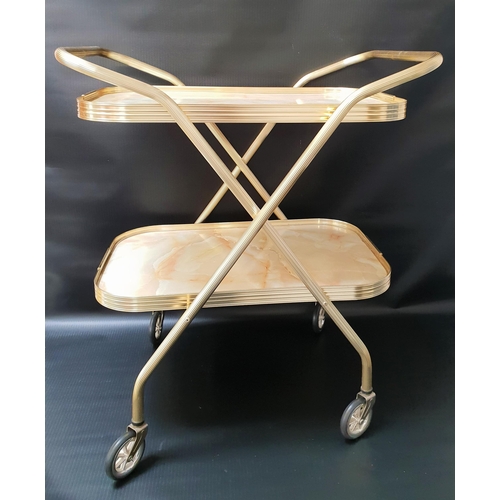 572 - GILT METAL TEA TROLLEY
with two folding tiers, on casters, 72cm high