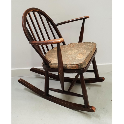 575 - ERCOL OAK AND ELM ROCKING CHAIR 
with an arched spindle back above a shaped seat, on rockers