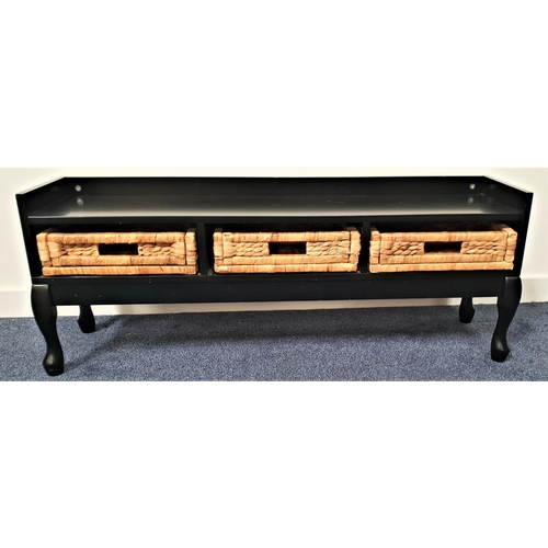 602 - EBONISED LOW CUPBOARD
with a three quarter gallery top above three woven rattan drawers, standing on... 