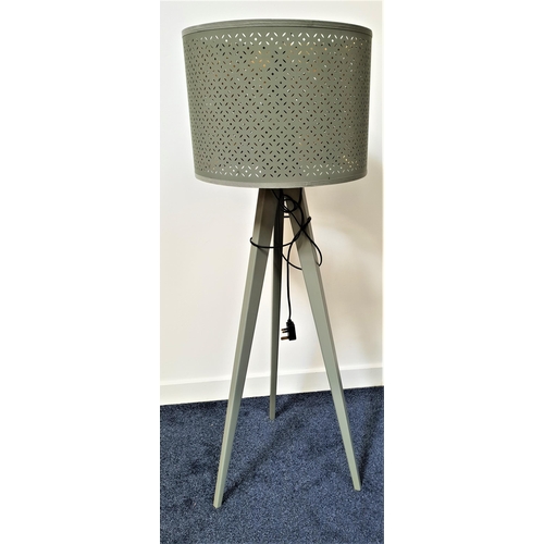 603 - TRIPOD STANDARD LAMP
on shaped supports with a circular pierced shade, 146cm high