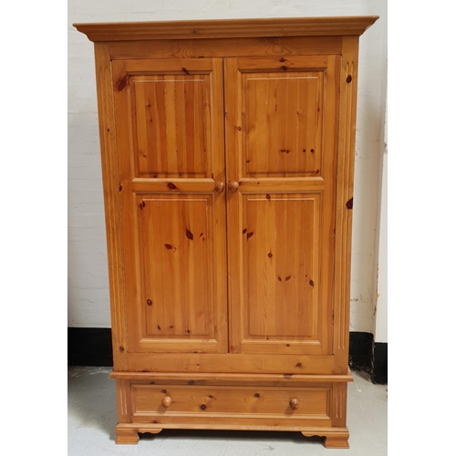 497 - WAXED PINE WARDROBE
with a pair of panelled doors opening to reveal hanging space, with a panelled d... 