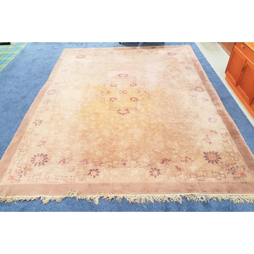 509 - LARGE CHINESE STYLE WASH RUG
with a pale brown and mauve ground with floral motifs, fringed, 368cm x... 