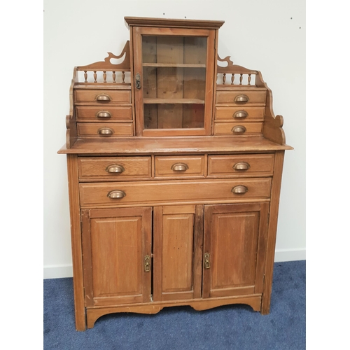 590 - PINE SIDE CABINET
with a shaped raised back centred with a glass cabinet and flanked by three pairs ... 