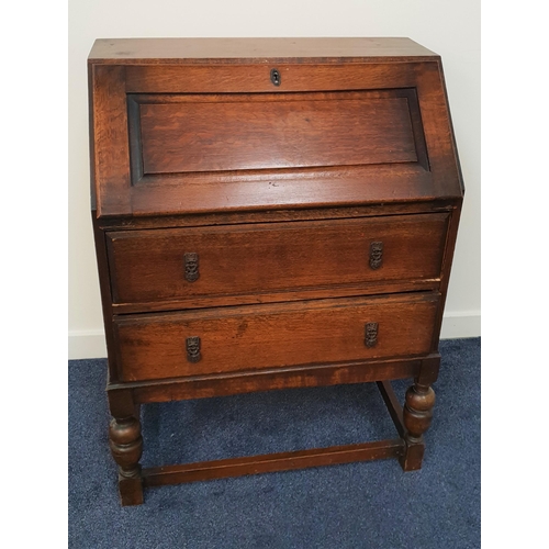 597 - OAK BUREAU
with a panelled fall flap above two drawers, standing on turned front supports, 101cm hig... 