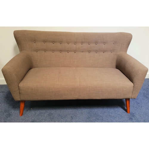 609 - RETRO STYLE WING BACK SOFA
with a shaped button back above shaped arms, standing on tapering support... 