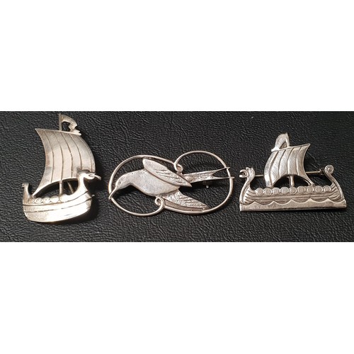 88 - THREE SHETLAND SILVER BROOCHES
comprising two Viking ships and one with swallow decoration (3)