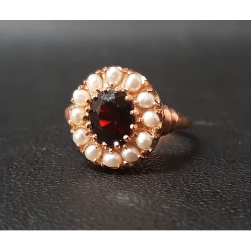 100 - GARNET AND PEARL CLUSTER RING
the central oval cut garnet approximately 1ct in twelve pearl surround... 