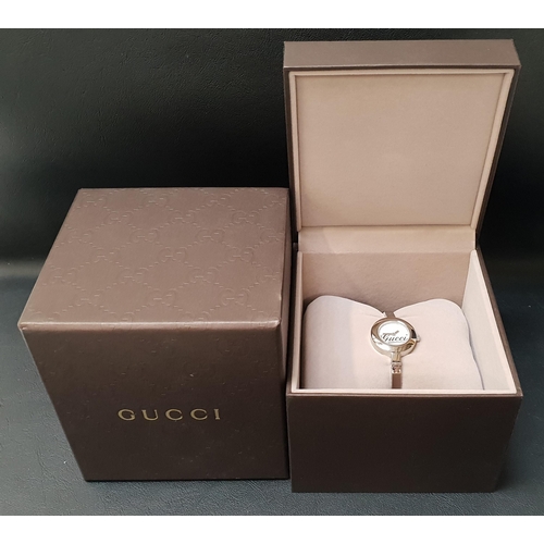 120 - LADIES GUCCI WRISTWATCH
the silvered dial with logo detail, on bracelet strap, with box and instruct... 