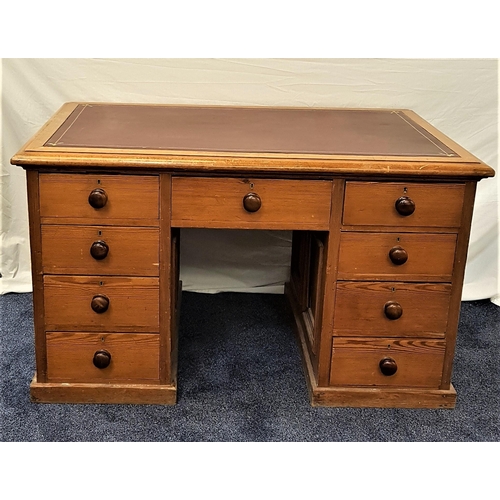 581 - PITCH PINE PARTNERS DESK
with an inset leather top above drawers and two cupboards to one side, the ... 