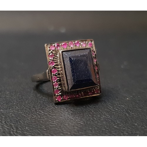 77 - SAPPHIRE AND RUBY CLUSTER DRESS RING
the central rectangular step cut blue sapphire approximately 7.... 