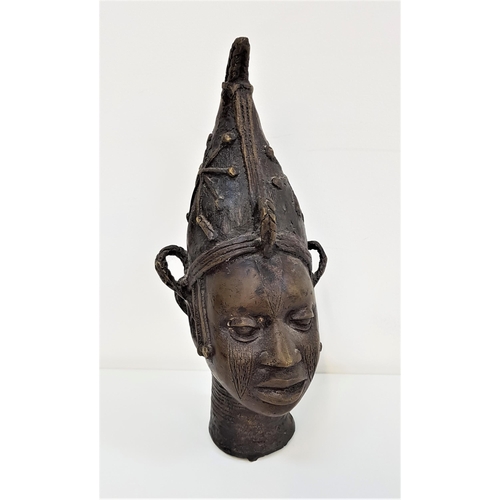 298 - BENIN BRONZE FEMALE HEAD
wearing a pinnacle hat with star decoration, her hair in plaits, 28cm high