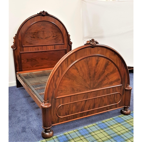 591 - MAHOGANY DOUBLE BED
with an arched panelled head and footboard together with a sprung base, 200cm x ... 