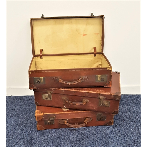 295 - THREE VINTAGE LEATHER SUITCASES
all with reinforced corners and leather handles, 65.5cm and 62cm wid... 