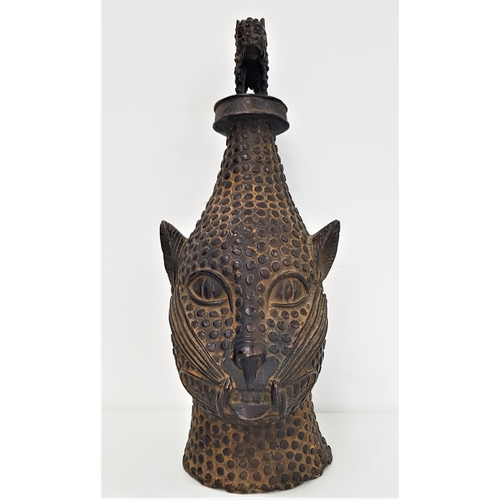 299 - BENIN BRONZE ANIMAL HEAD
with textured decoration, surmounted with a similar cat like animal, 50cm h... 