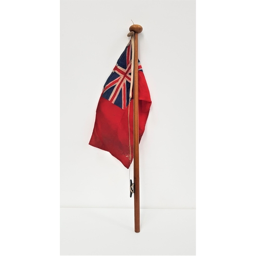 324 - BRITISH MARITIME RED ENSIGN
on a mahogany pole, 81cm high